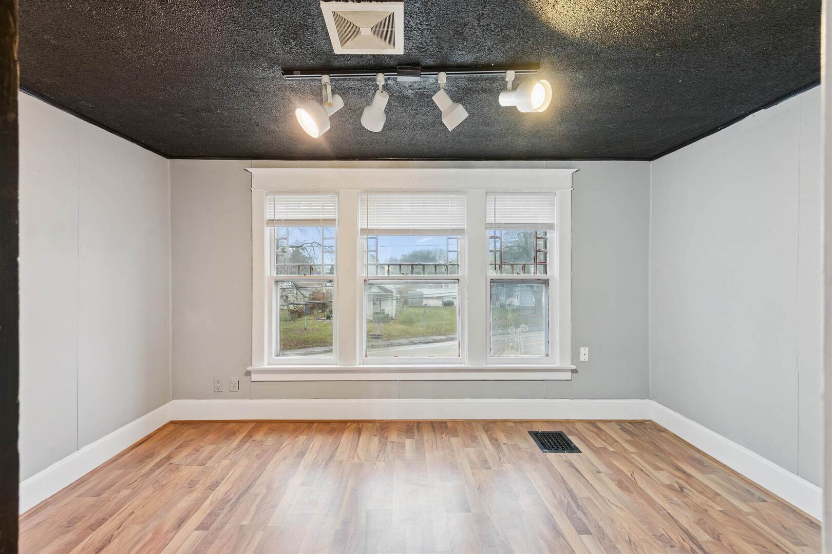 2828 16th Street Moline, IL 61265 - Photo 18 of 39 a view of an empty room with wooden floor and a window