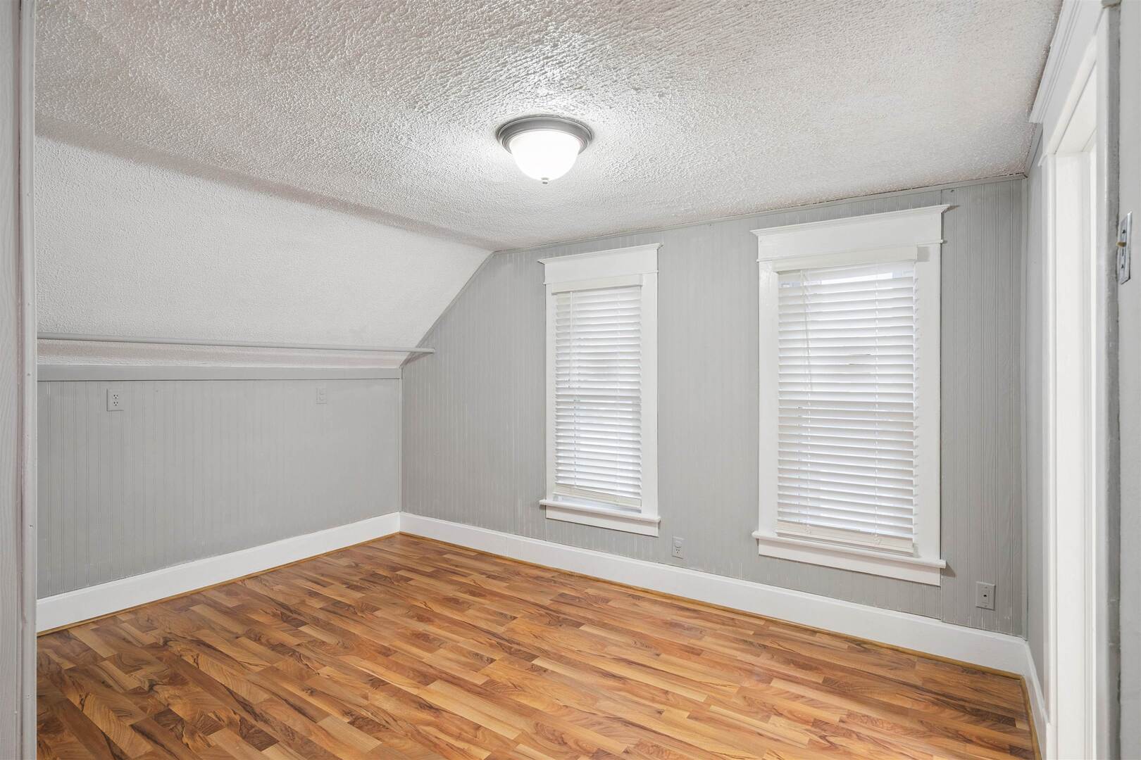 2828 16th Street Moline, IL 61265 - Photo 19 of 39 an empty room with wooden floor and windows