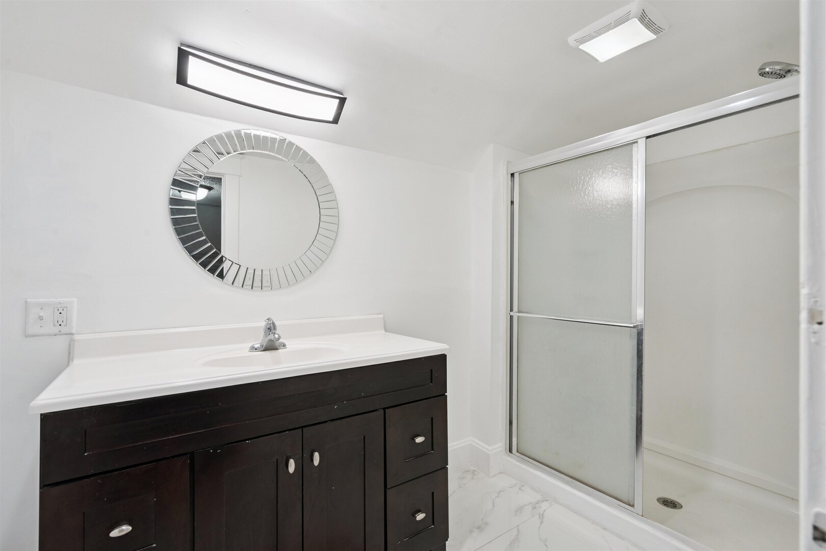 2828 16th Street Moline, IL 61265 - Photo 21 of 39 a bathroom with a sink a shower and a mirror