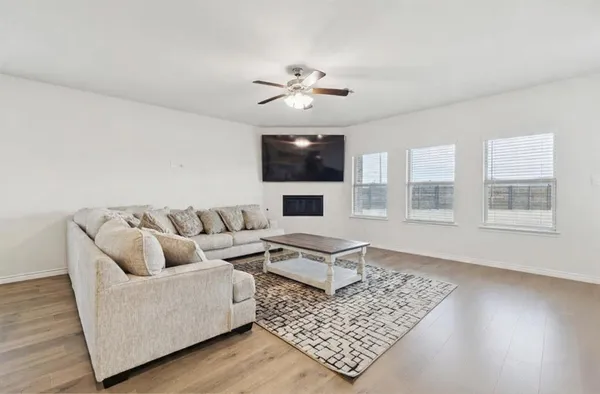 a living room with furniture and a flat screen tv
