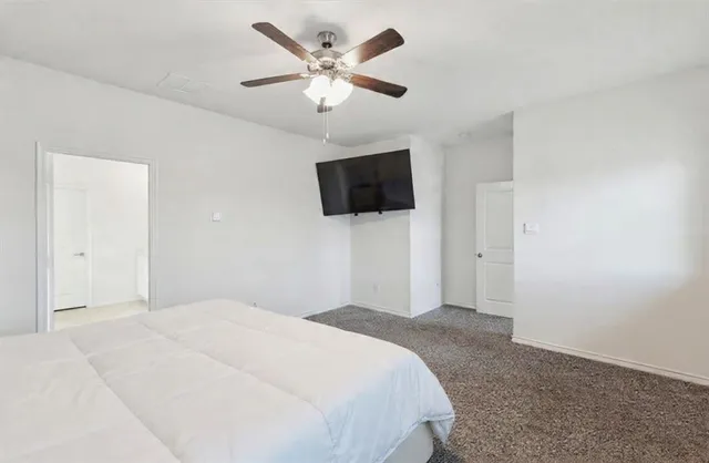 a bedroom with a bed and a flat screen tv