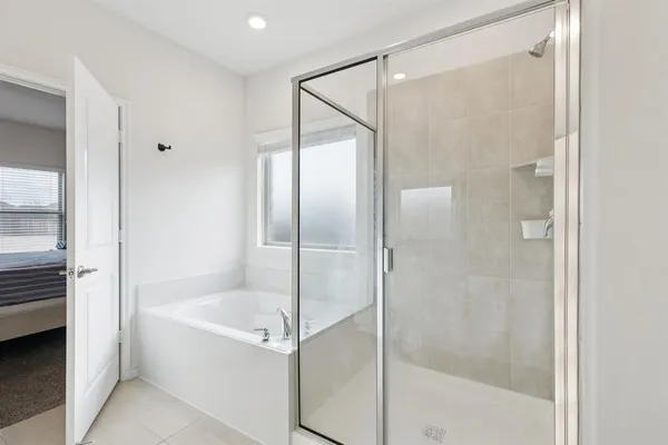 a bathroom with a bathtub and a shower