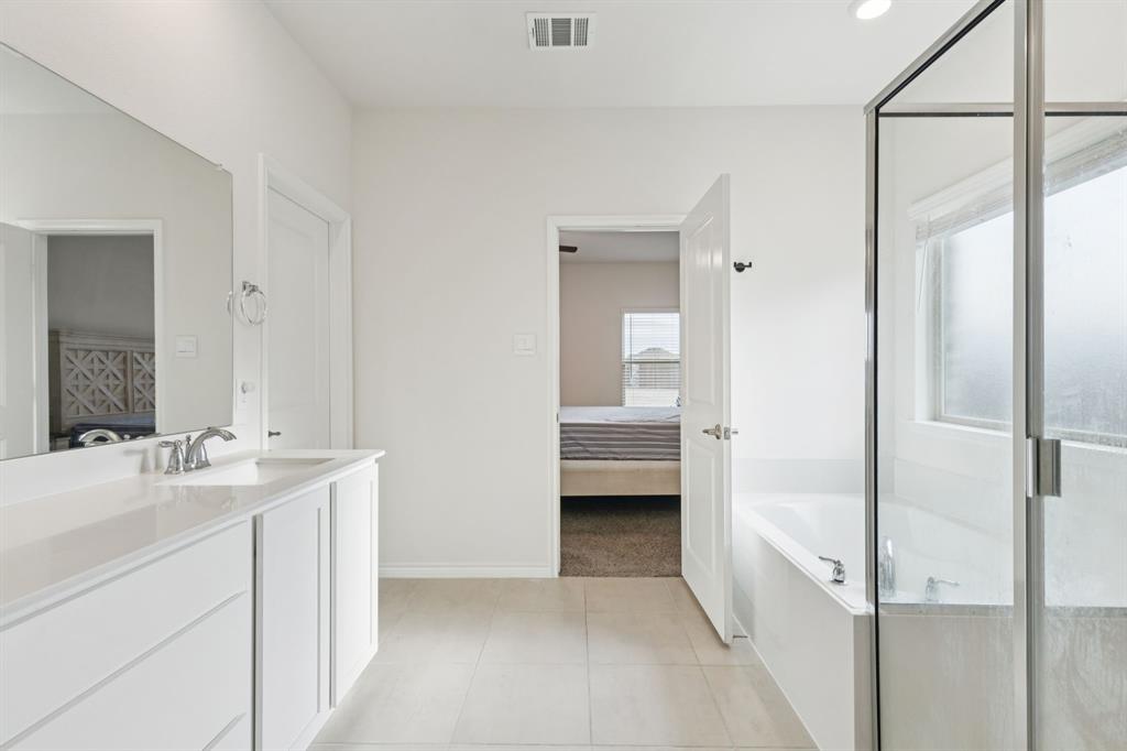 3400 Honey Hl Road Aubrey, TX 76227 - Photo 18 of 39 a en suite bathroom with a sink a mirror and a shower