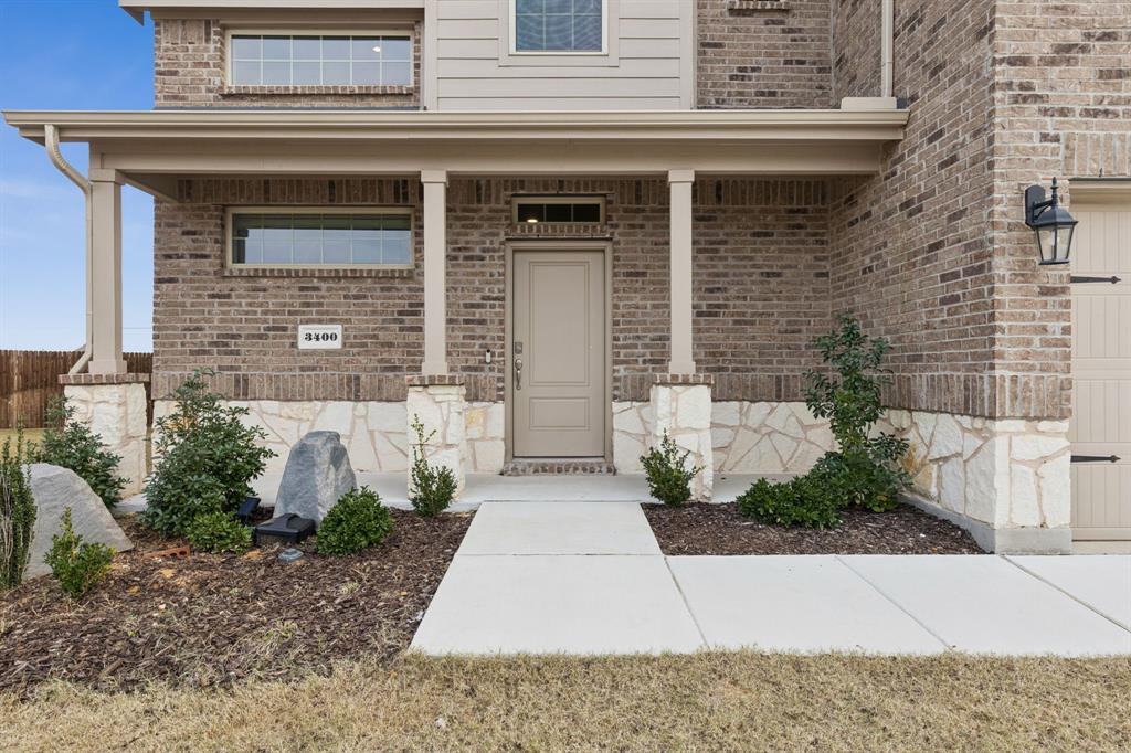 3400 Honey Hl Road Aubrey, TX 76227 - Photo 2 of 39 a front view of a house with garden