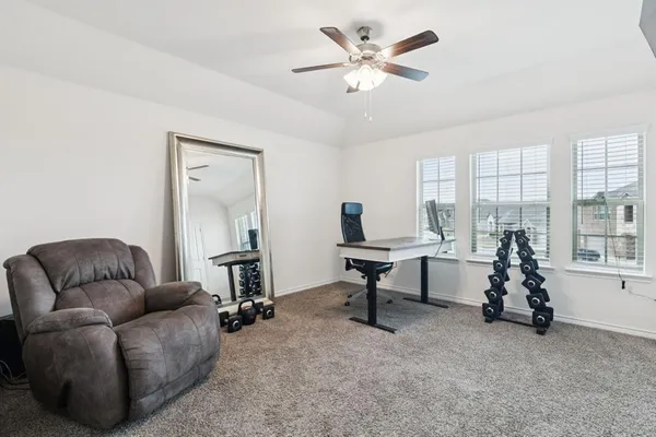 a living room with furniture a window and a flat screen tv