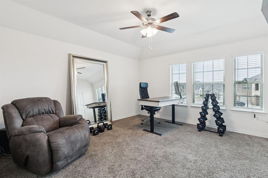 3400 Honey Hl Road Aubrey, TX 76227 - Photo 23 of 39 a living room with furniture a window and a flat screen tv