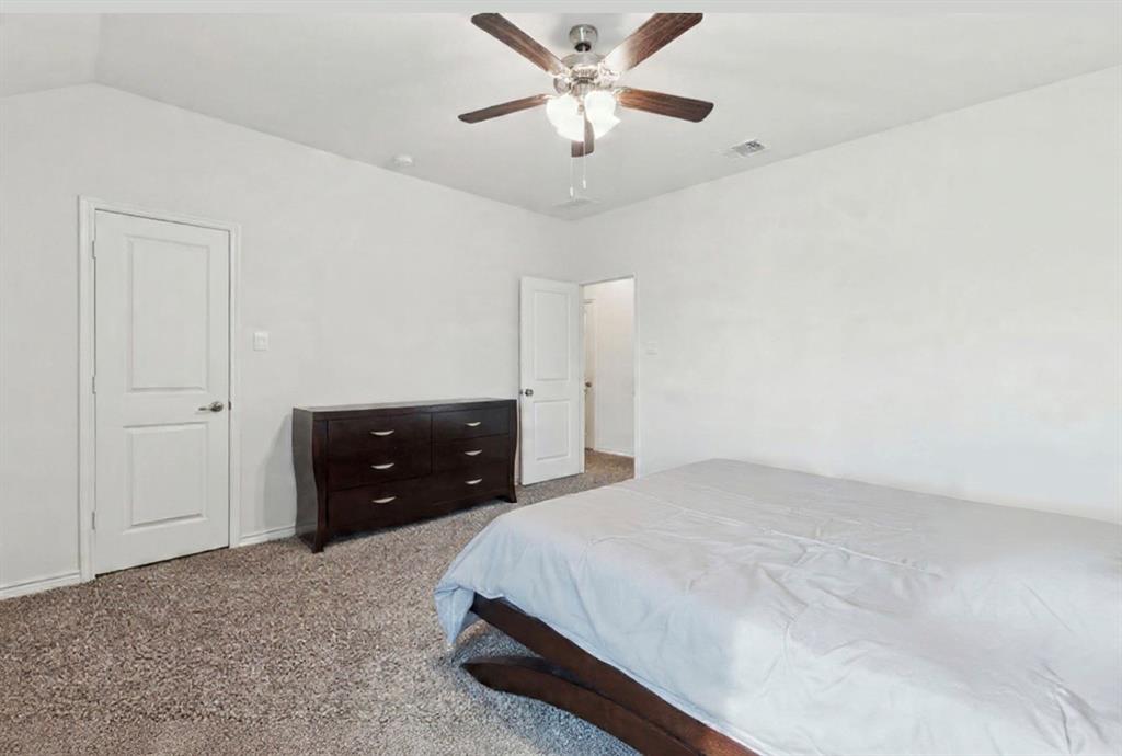 3400 Honey Hl Road Aubrey, TX 76227 - Photo 25 of 39 a bedroom with a bed and a ceiling fan