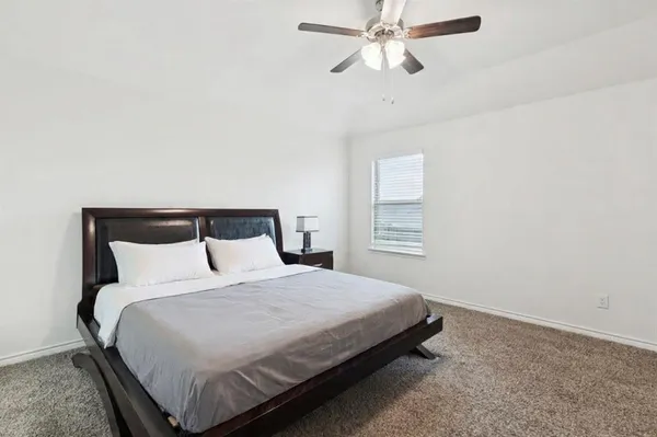 a bedroom with a bed and window