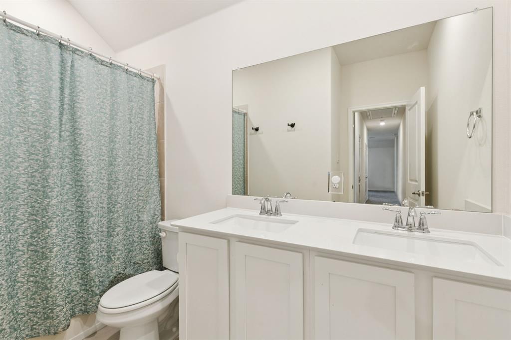 3400 Honey Hl Road Aubrey, TX 76227 - Photo 27 of 39 a bathroom with a sink a toilet and a mirror