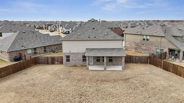 an aerial view of a house with a yard and mountain view