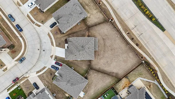 an aerial view of residential houses with outdoor space