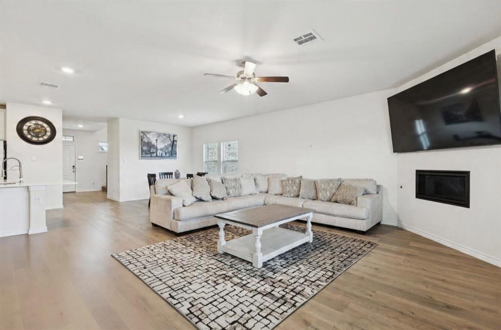 3400 Honey Hl Road Aubrey, TX 76227 - Photo 10 of 39 a living room with furniture and a flat screen tv