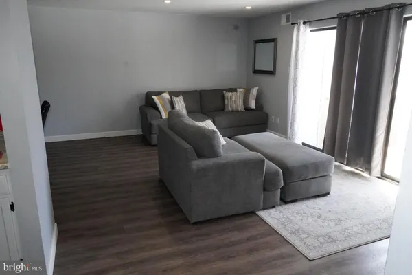 a living room with furniture and a rug
