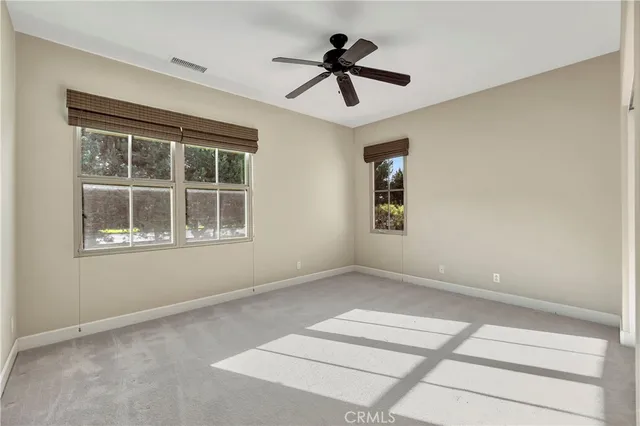 a view of empty room with ceiling fan