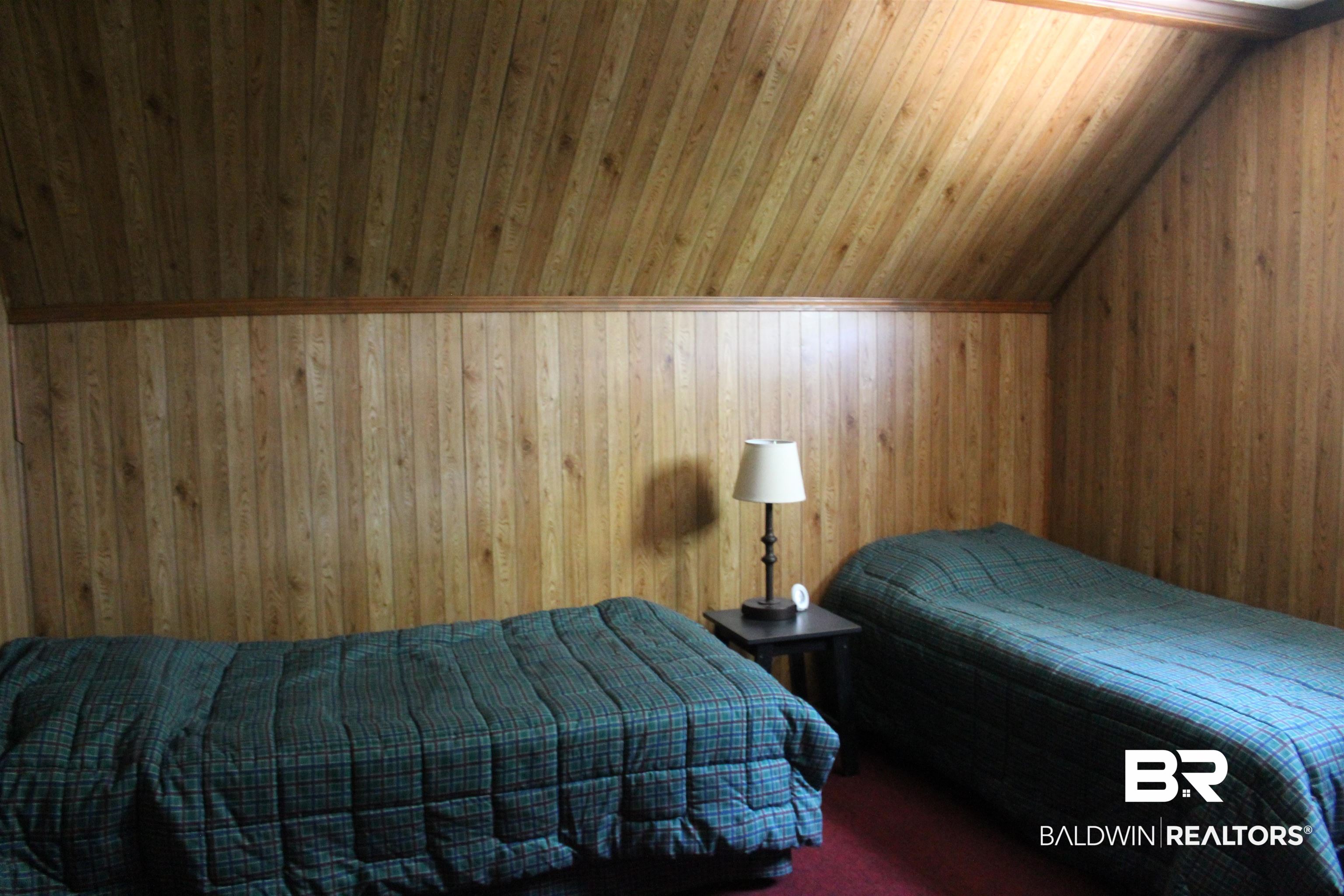 6447 Henderson Road Lowndesboro, AL 36752 - Photo 19 of 22 Bedroom with wood walls and vaulted ceiling