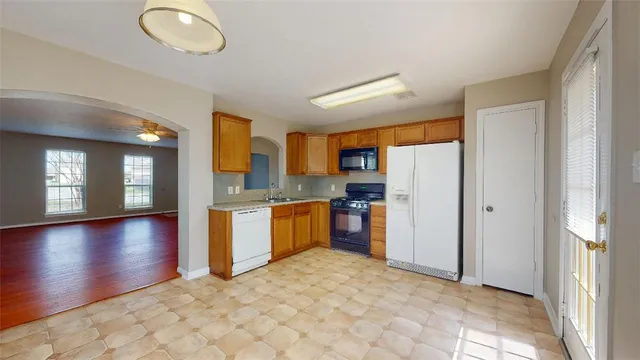 a view of a kitchen with a sink and a refrigerator