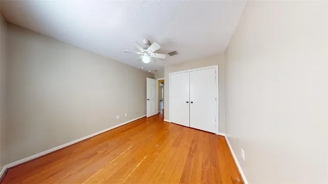 a view of a big room with closet and ceiling fan