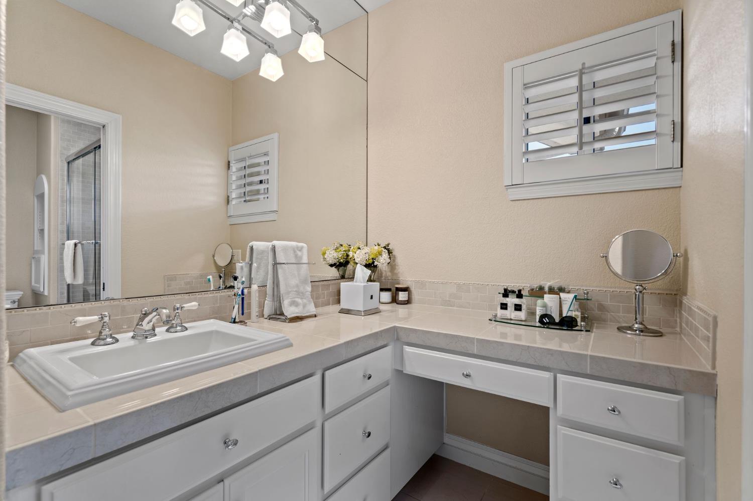 10676 Wilton Road Elk Grove, CA 95624 - Photo 60 of 71 a bathroom with a sink double vanity and a mirror
