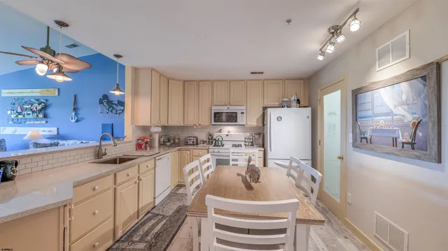a kitchen with a sink a refrigerator and cabinets