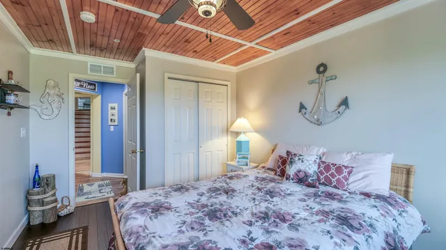 a bedroom with a bed and a mirror