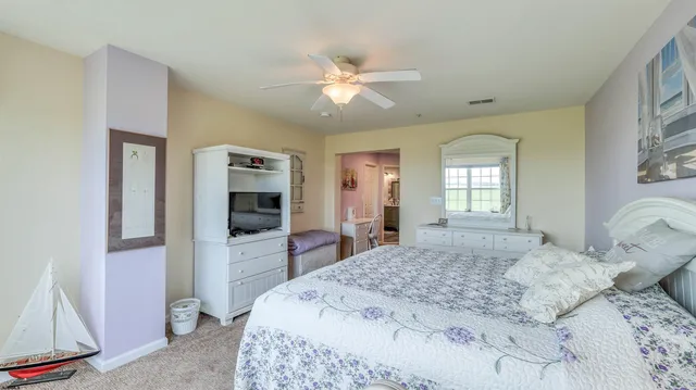 a bedroom with a large bed and a window