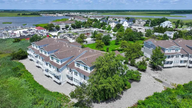 an aerial view of a house with outdoor space and a lake view