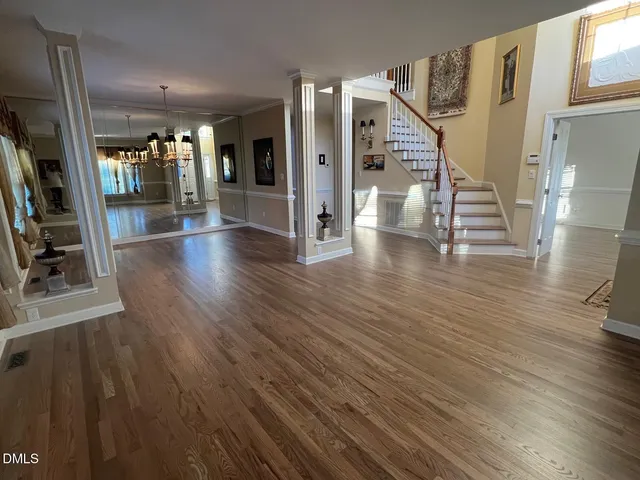 a view of entryway and hall with wooden floor