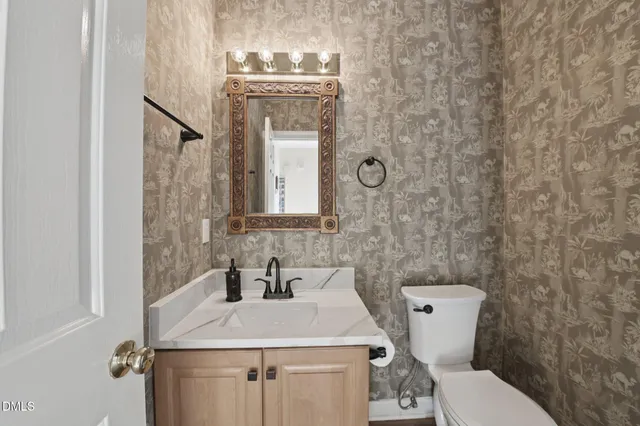 an empty room with windows and ceiling fan