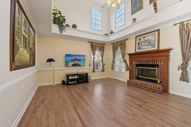 a view of a room with wooden floor and furniture