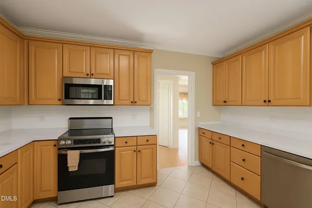 a kitchen with stainless steel appliances granite countertop a refrigerator sink and cabinets