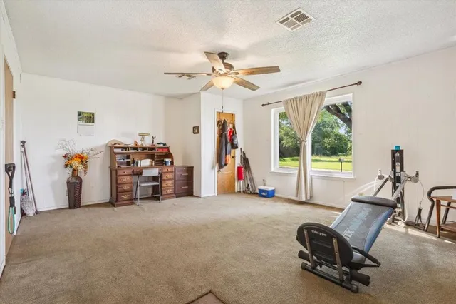 a view of a livingroom with furniture and a ceiling fan