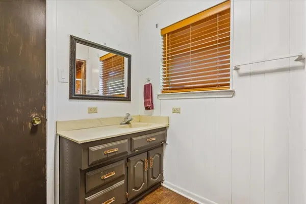 a bathroom with a sink a vanity and a window