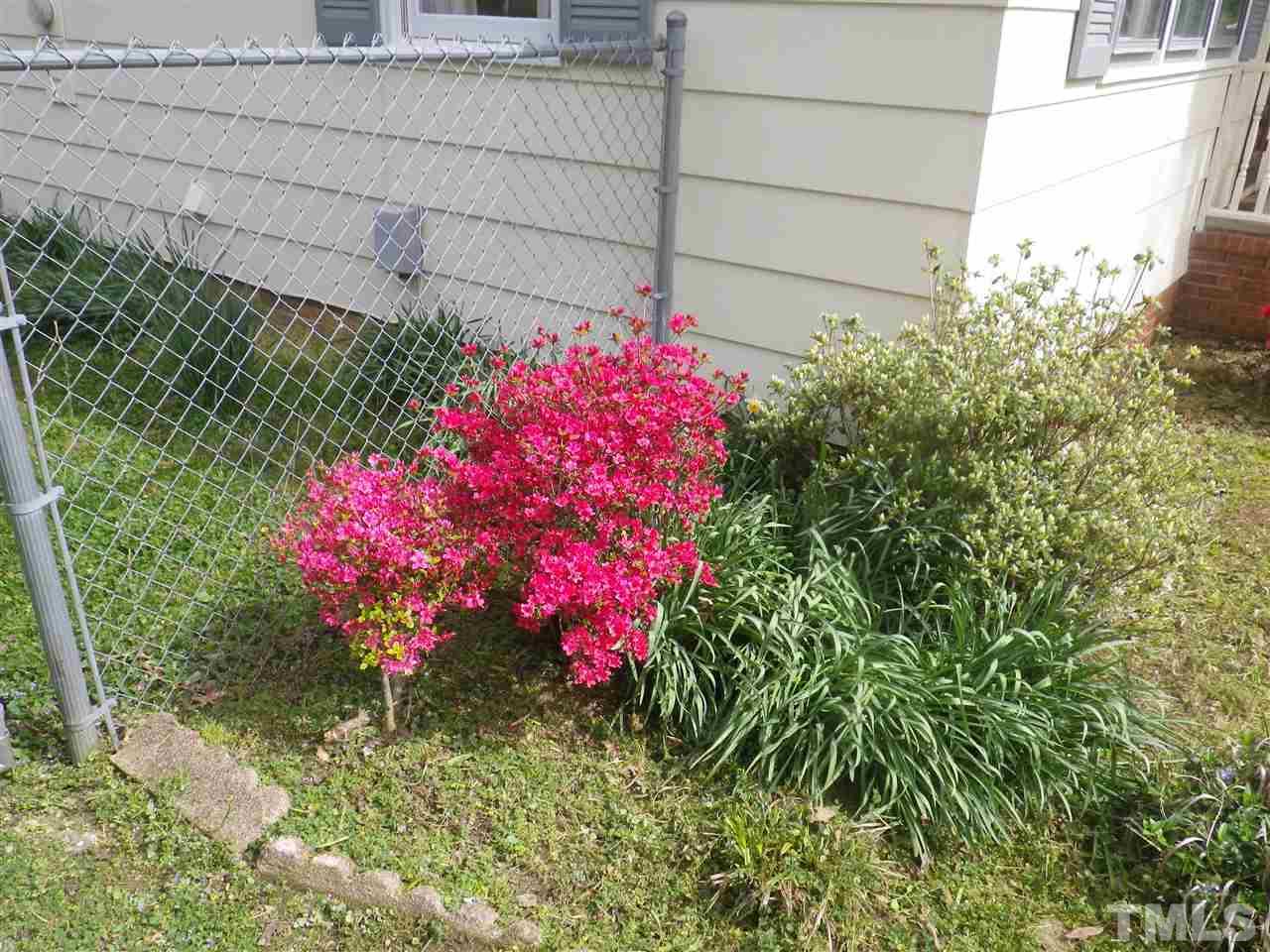 5024 Wickham Road Raleigh, NC 27606 - Photo 12 of 14 a pink flowers in front of yellow house