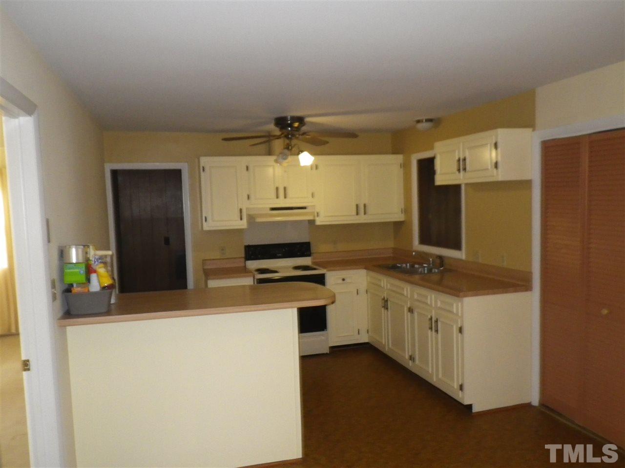 5024 Wickham Road Raleigh, NC 27606 - Photo 4 of 14 a kitchen with stainless steel appliances a stove refrigerator and a refrigerator