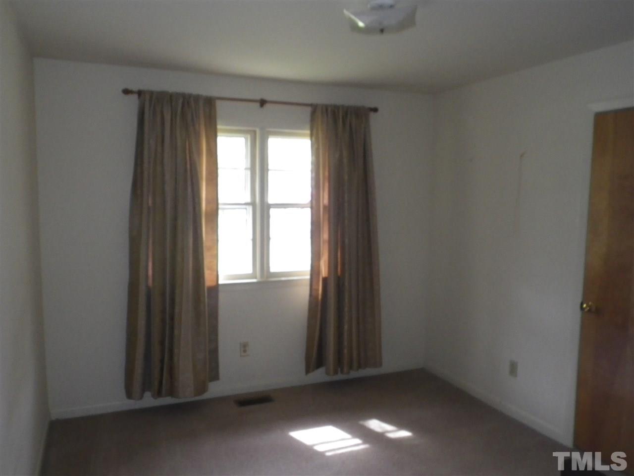 5024 Wickham Road Raleigh, NC 27606 - Photo 6 of 14 an empty room with windows in back
