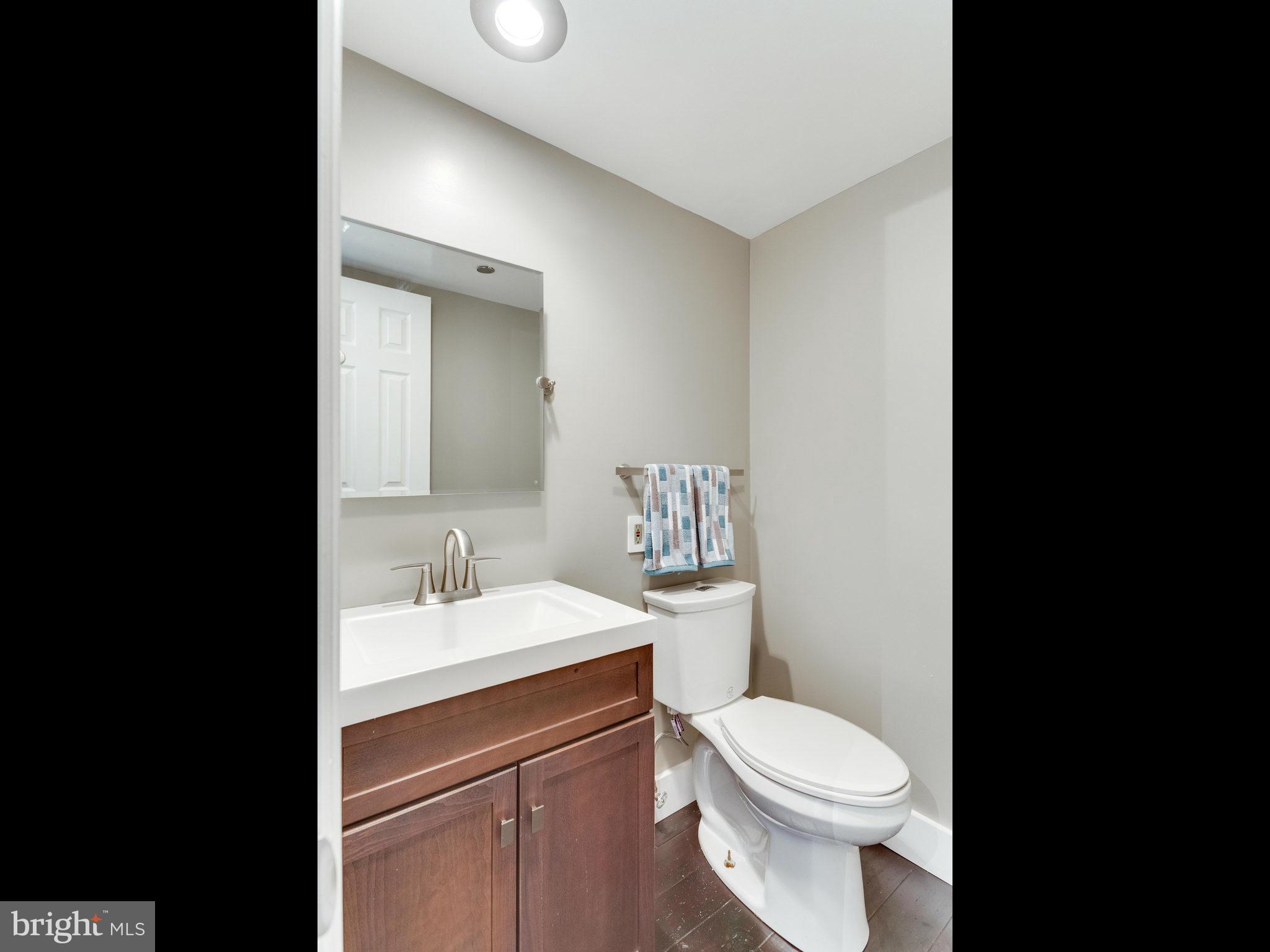 1301 North Courthouse Road, Unit 1411 Arlington, VA 22201 - Photo 16 of 30 a bathroom with a sink toilet and mirror