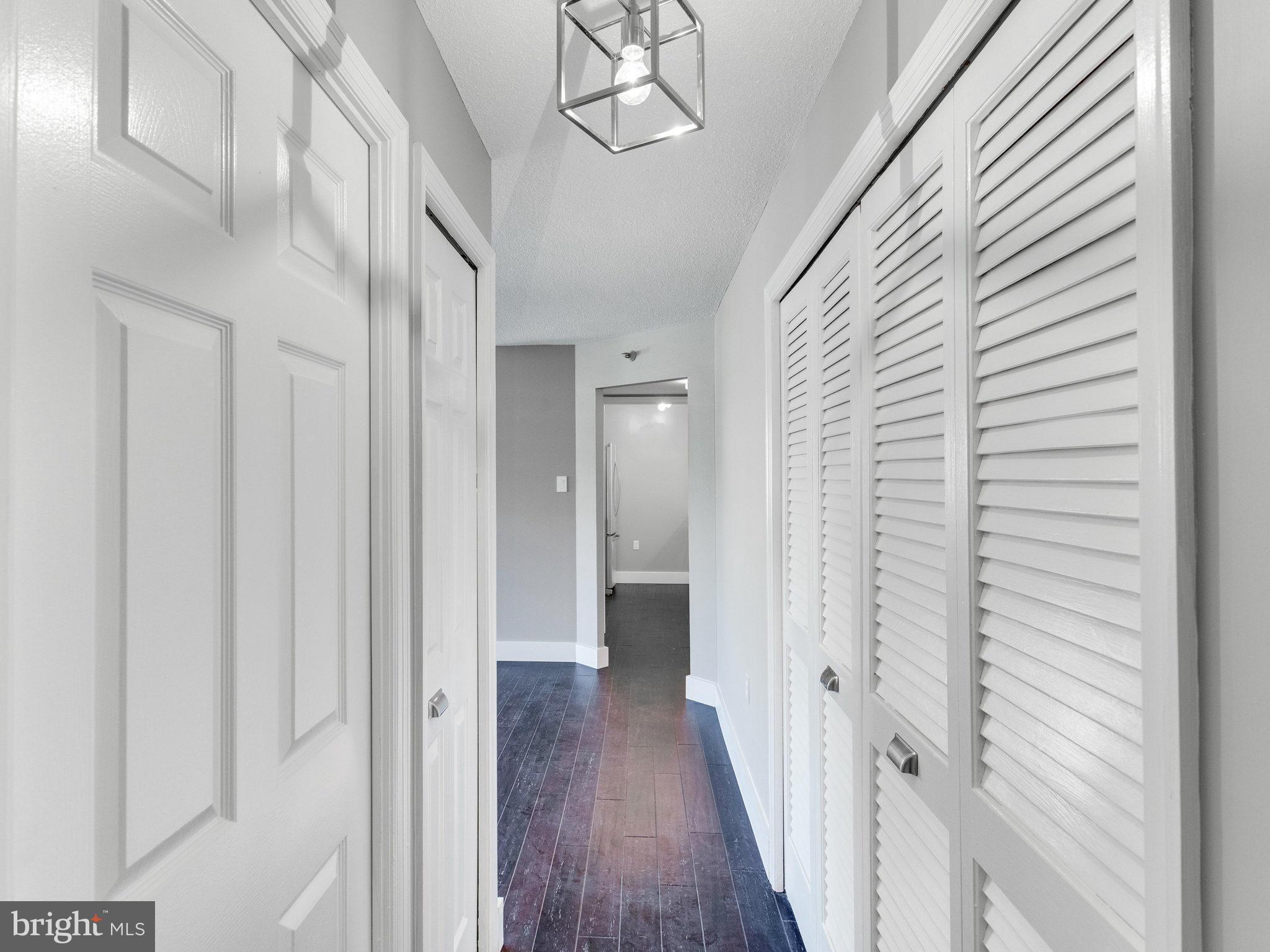 1301 North Courthouse Road, Unit 1411 Arlington, VA 22201 - Photo 22 of 30 a view of a hallway with wooden floor and staircase