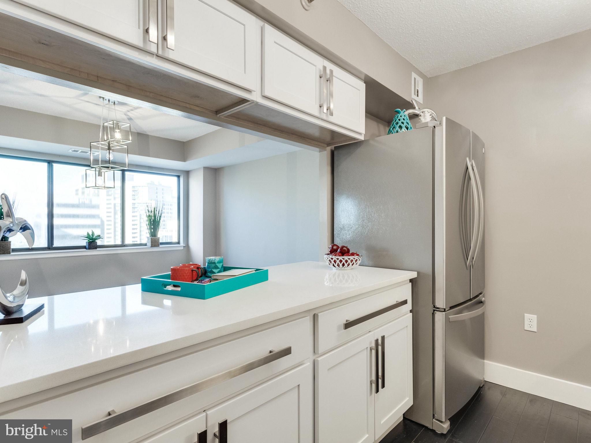 1301 North Courthouse Road, Unit 1411 Arlington, VA 22201 - Photo 5 of 30 a kitchen with a sink and a refrigerator