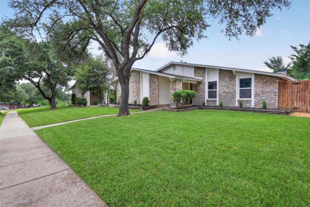 2005 Chestnut Road Carrollton, TX 75007 - Photo 4 of 35 a front view of a house with a yard and trees