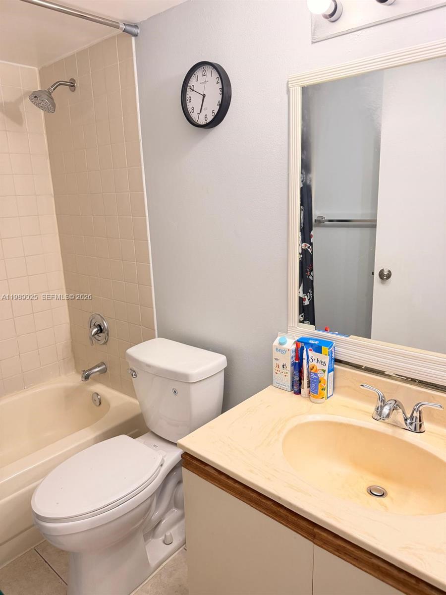 8821 Wiles Road, Unit 108 Coral Springs, FL 33067 - Photo 16 of 46 a bathroom with a sink and a toilet