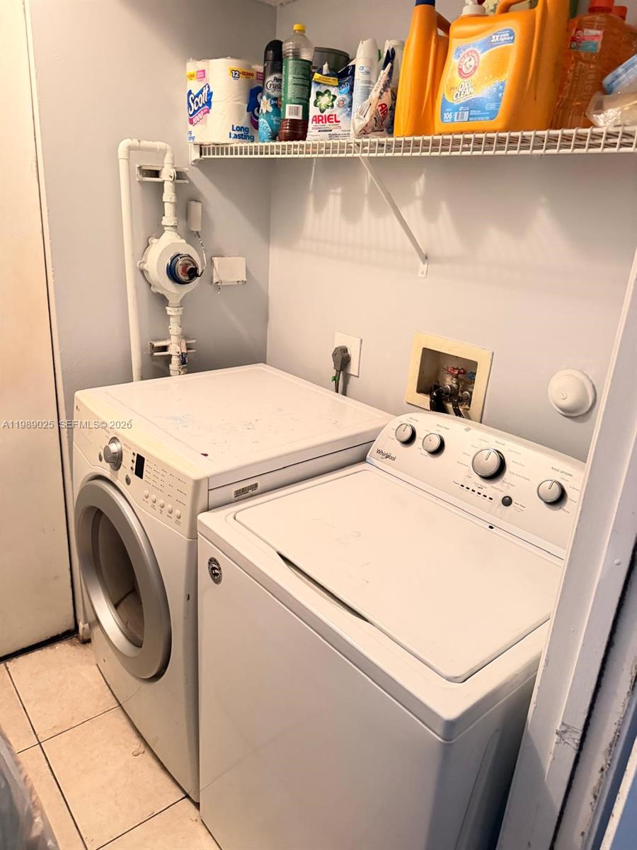 8821 Wiles Road, Unit 108 Coral Springs, FL 33067 - Photo 20 of 46 a utility room with dryer and washer