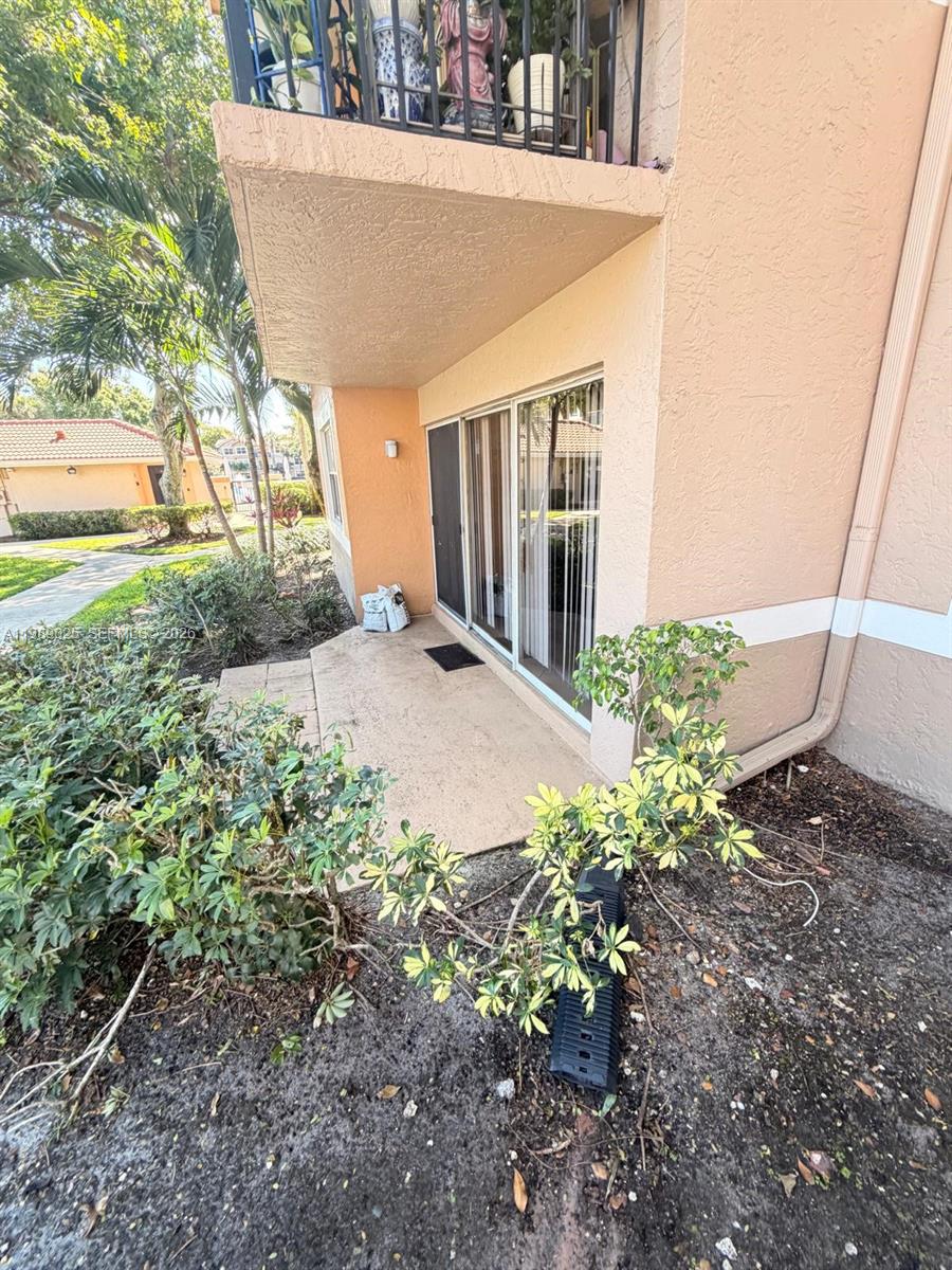 8821 Wiles Road, Unit 108 Coral Springs, FL 33067 - Photo 2 of 46 a view of a house with a yard
