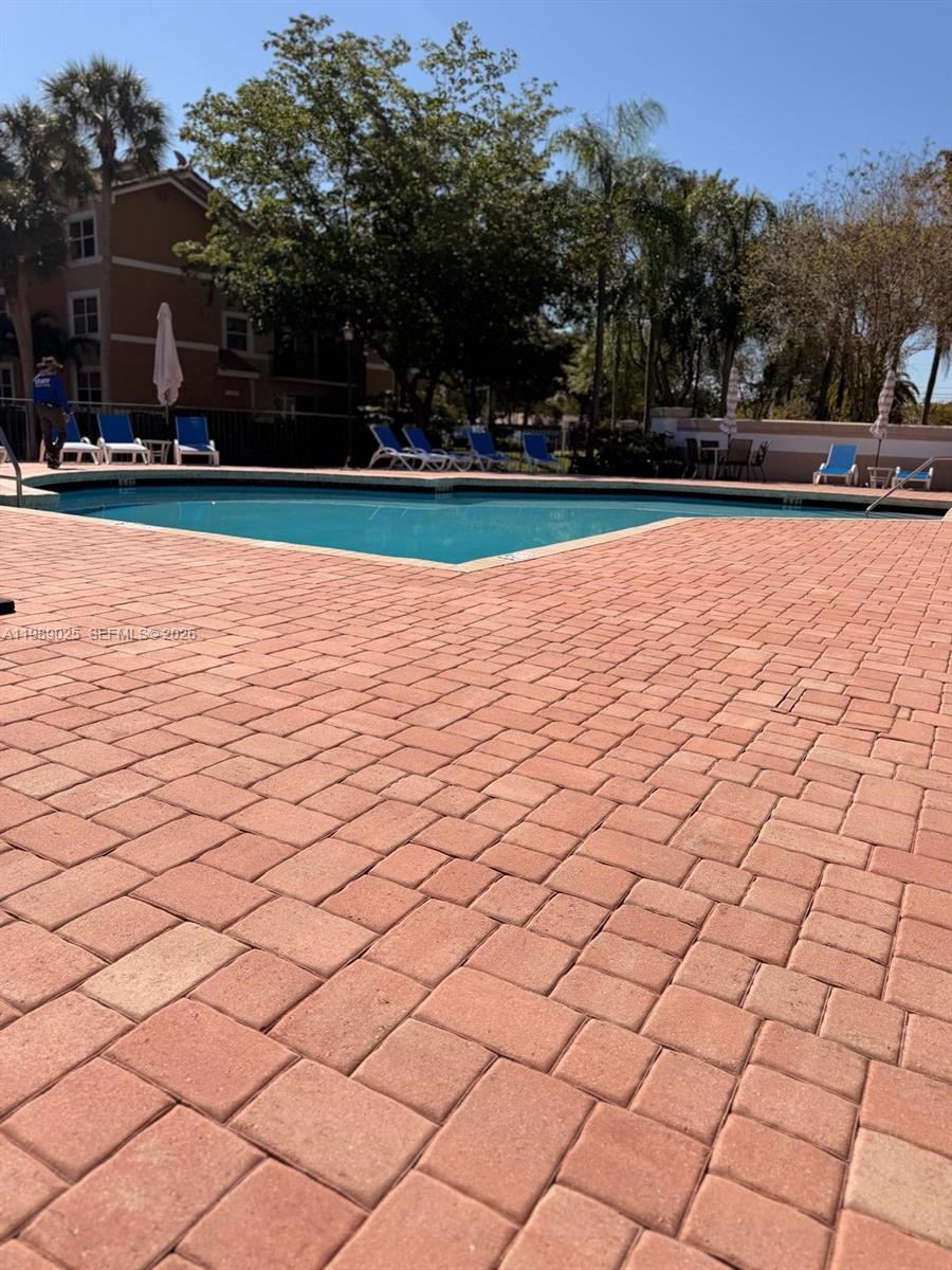 8821 Wiles Road, Unit 108 Coral Springs, FL 33067 - Photo 22 of 46 a view of a yard and basketball court