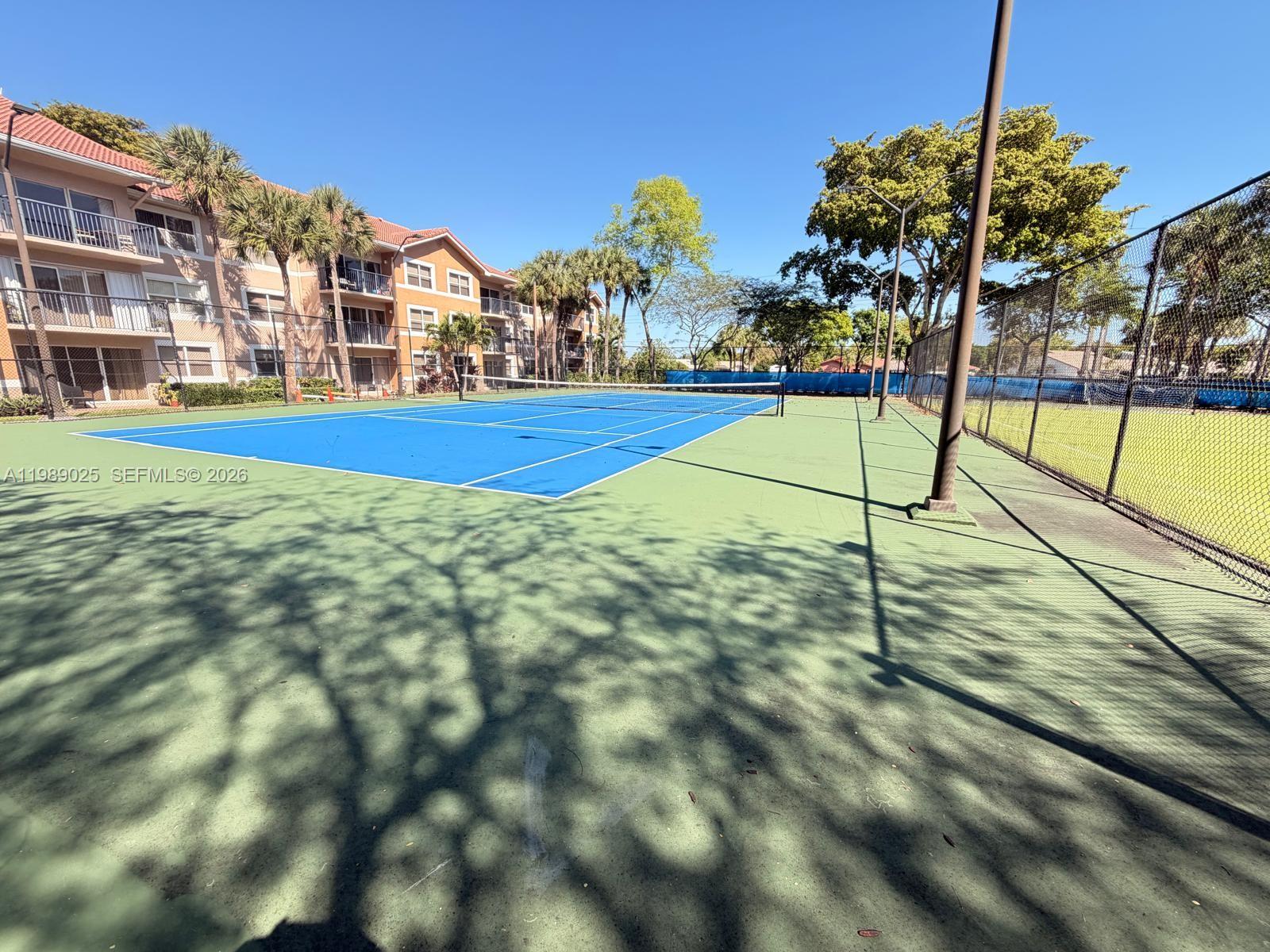 8821 Wiles Road, Unit 108 Coral Springs, FL 33067 - Photo 31 of 46 a view of tall trees with a view of building