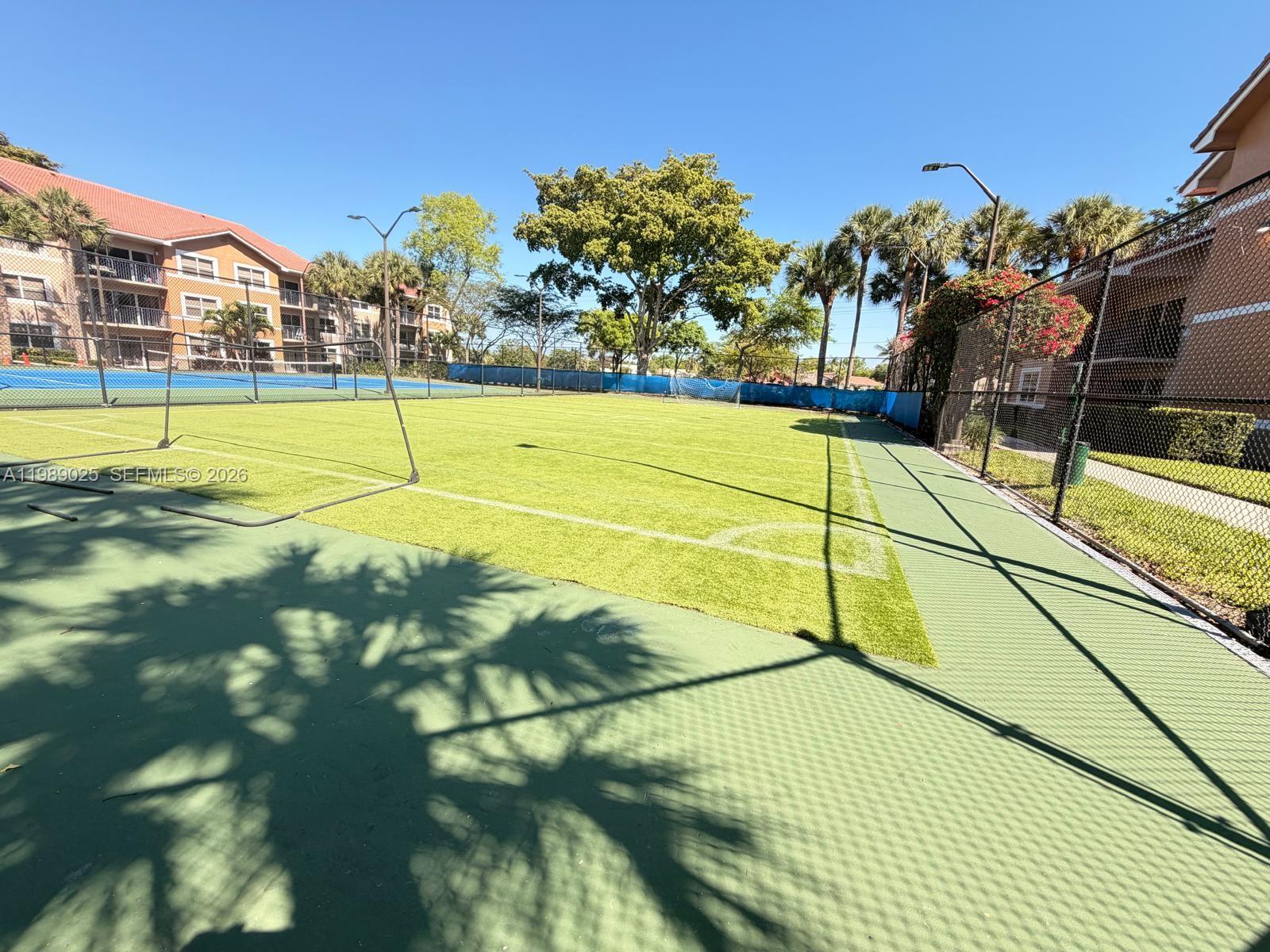 8821 Wiles Road, Unit 108 Coral Springs, FL 33067 - Photo 32 of 46 a view of a swimming pool with a yard