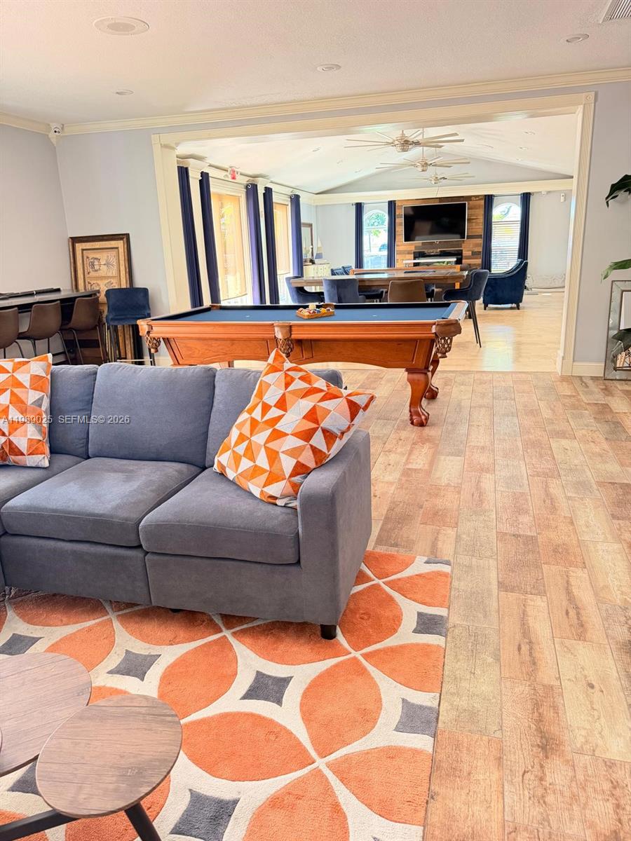 8821 Wiles Road, Unit 108 Coral Springs, FL 33067 - Photo 34 of 46 a living room with furniture and a flat screen tv