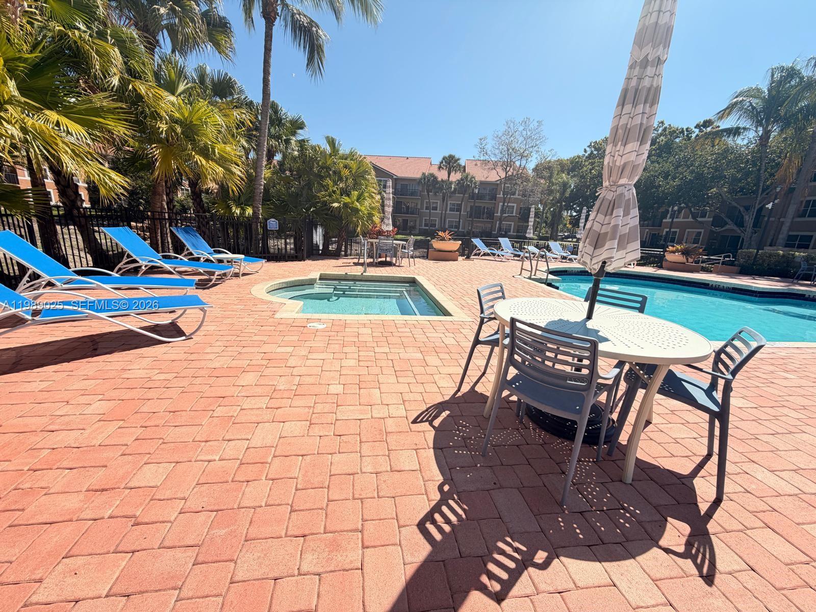 8821 Wiles Road, Unit 108 Coral Springs, FL 33067 - Photo 36 of 46 a view of outdoor space yard swimming pool and patio