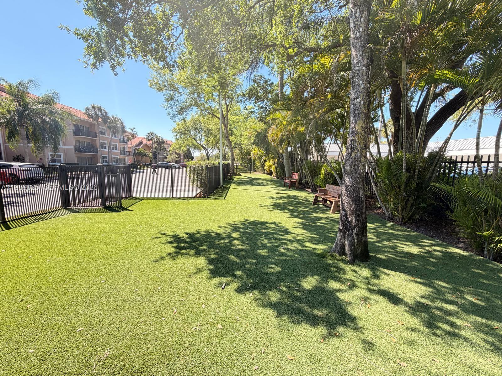 8821 Wiles Road, Unit 108 Coral Springs, FL 33067 - Photo 43 of 46 a swimming pool with outdoor seating and yard