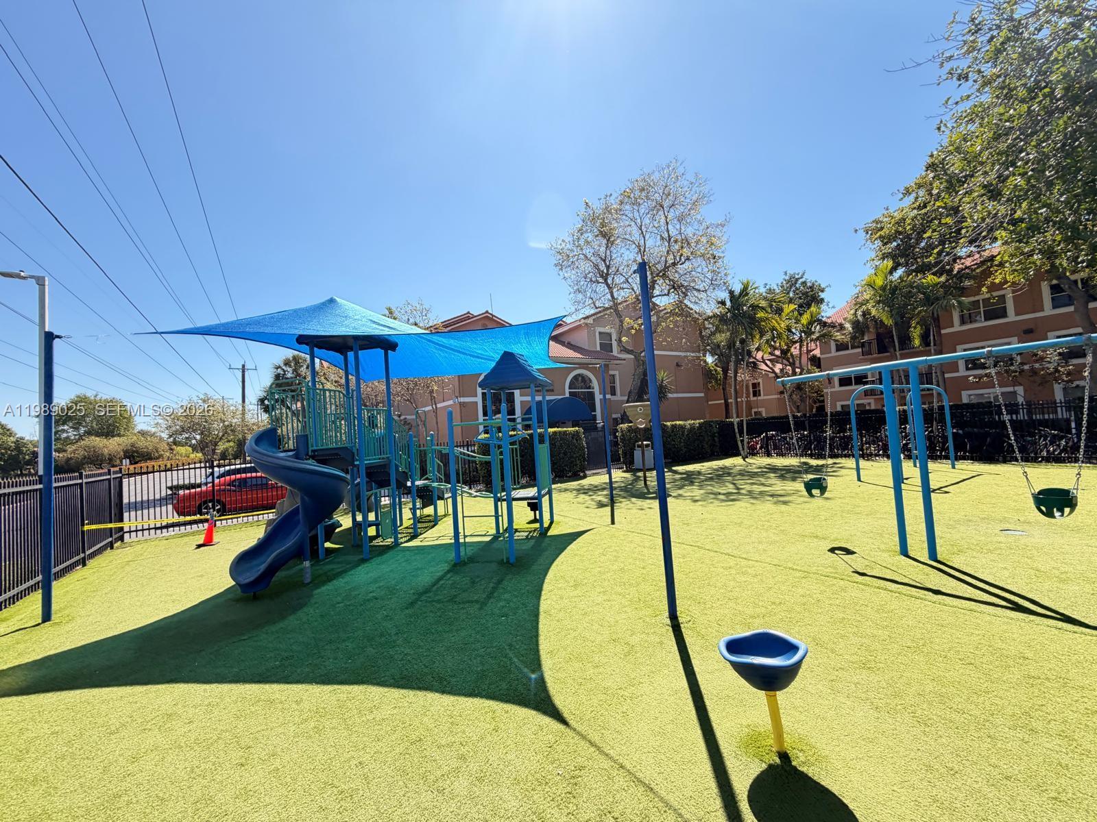 8821 Wiles Road, Unit 108 Coral Springs, FL 33067 - Photo 44 of 46 a view of a swimming pool with a patio