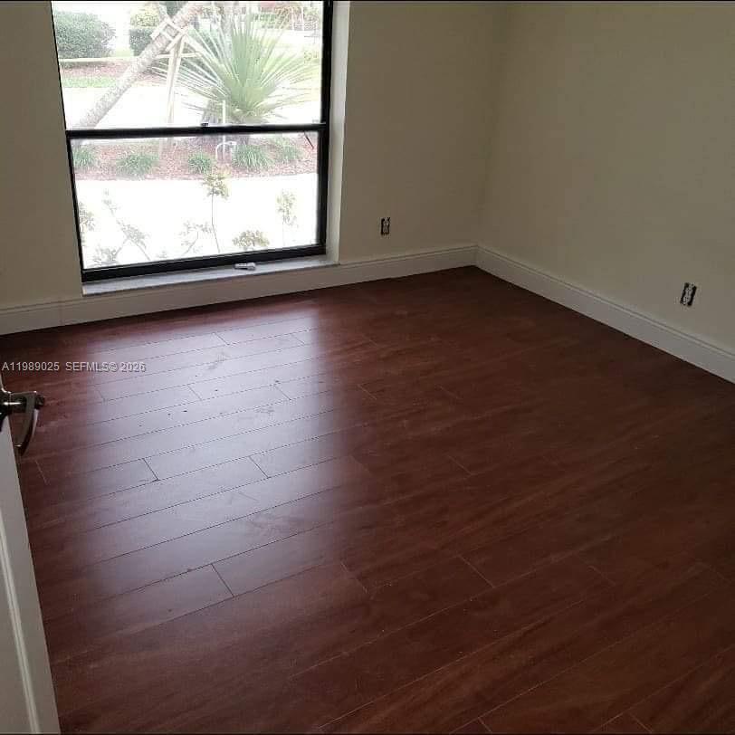 8821 Wiles Road, Unit 108 Coral Springs, FL 33067 - Photo 8 of 46 a view of a room with wooden floor and window